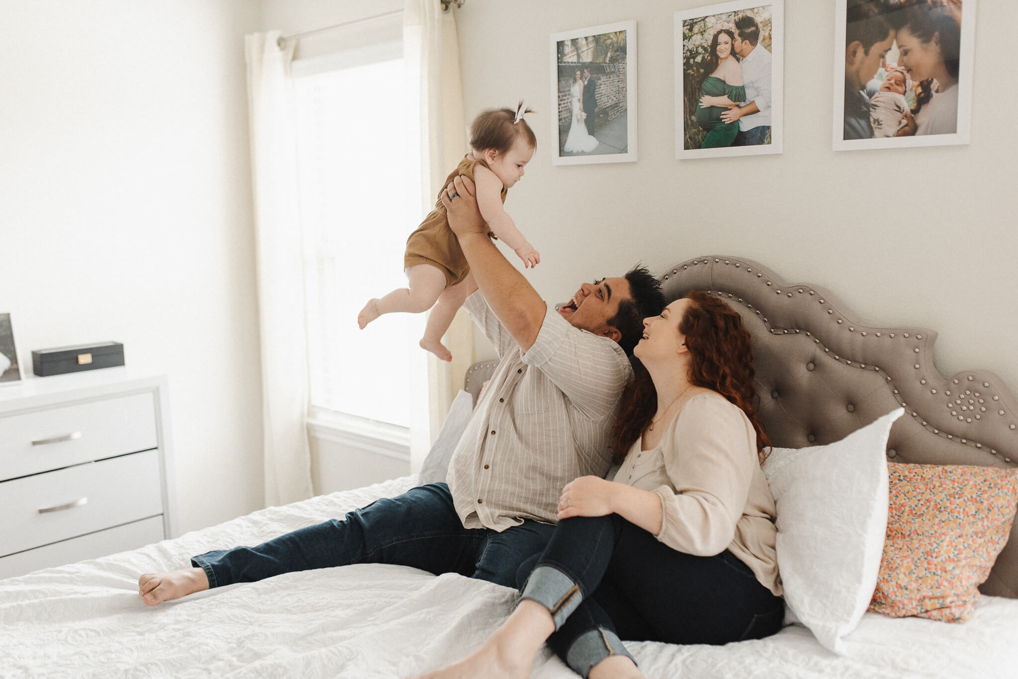 a young family of three plays with their toddler daughter in their dallas home