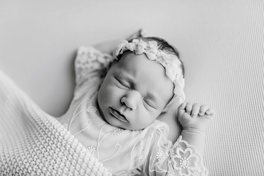 Peaceful newborn baby sleeping during in-home photography session in Frisco Texas