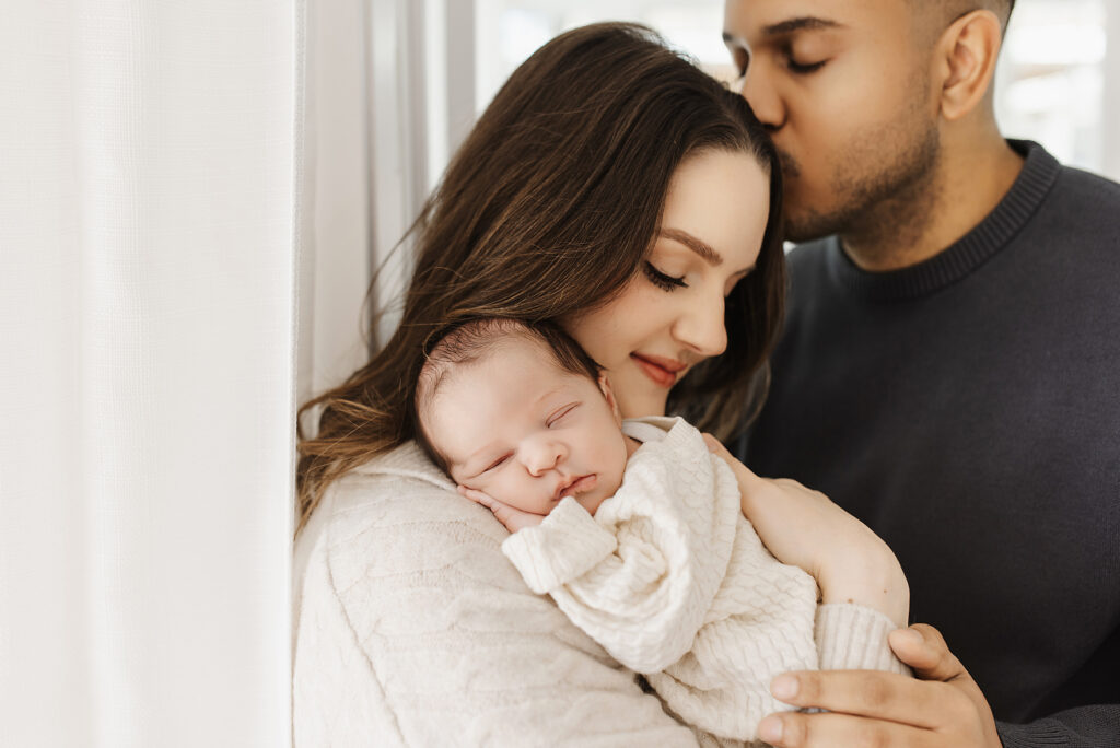 Mother and father holding newborn together lifestyle newborn photography McKinney TX