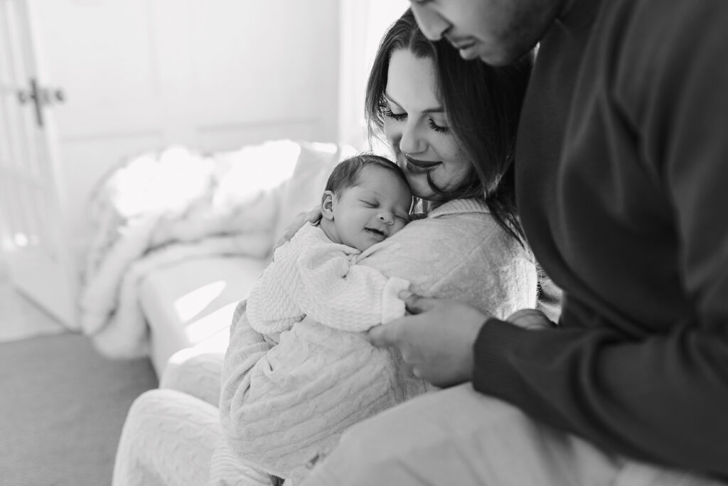 Parents holding newborn together lifestyle newborn photography McKinney TX