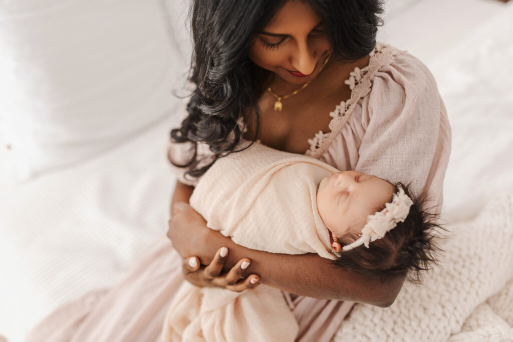 Newborn baby held in parent's arms, lifestyle newborn photography McKinney TX