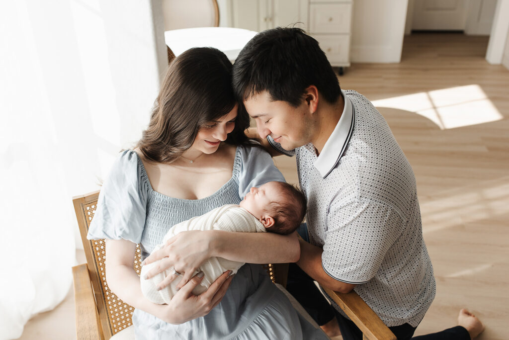 Newborn resting in moms arms natural light McKinney lifestyle photography
