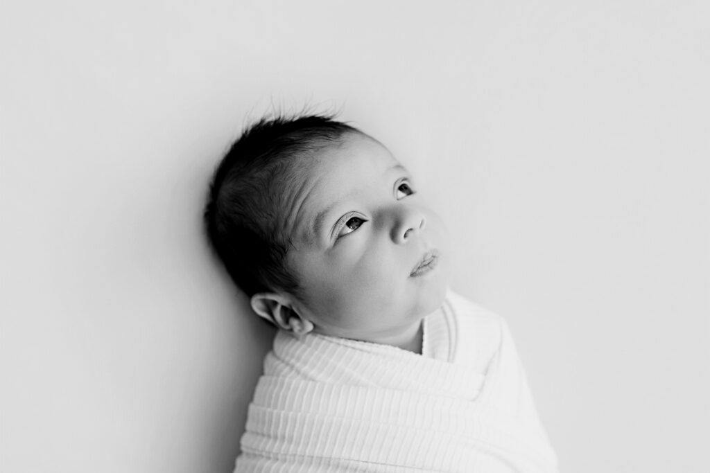 Newborn baby wrapped in neutral tones lifestyle session McKinney TX