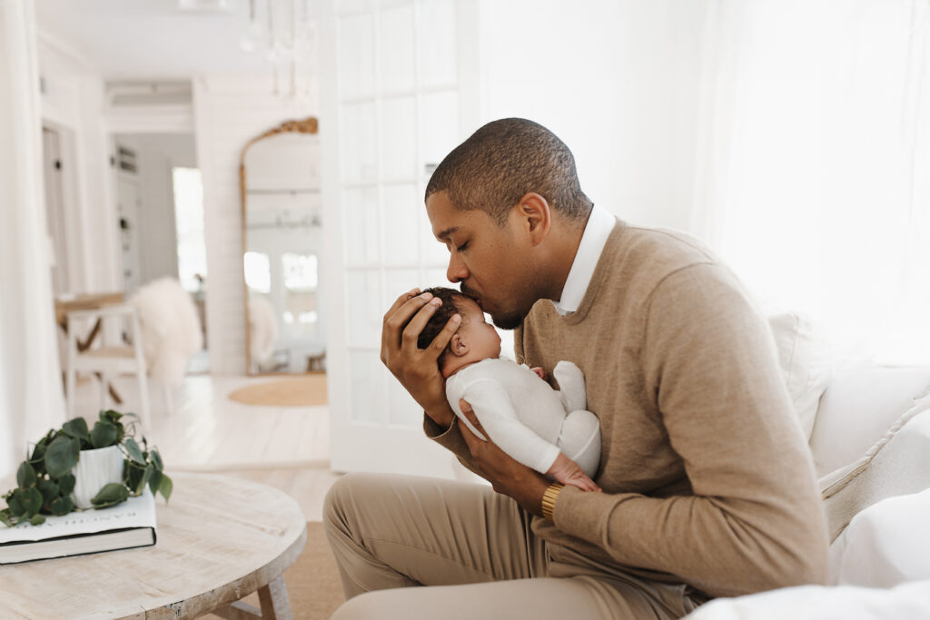 Lifestyle newborn session near Frisco Texas with newborn baby resting in father's hands